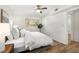 This bedroom features a large window, wood floor, ceiling fan, and a big bed at 1111 Clairemont Ave # P5, Decatur, GA 30030