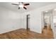 This empty bedroom features a ceiling fan, light walls, wood floors, and closet at 1111 Clairemont Ave # P5, Decatur, GA 30030