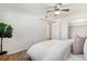Bright bedroom featuring a ceiling fan, light walls, wood floors, and closet at 1111 Clairemont Ave # P5, Decatur, GA 30030