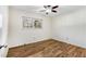 This bedroom features a ceiling fan, light walls, and wood floors at 1111 Clairemont Ave # P5, Decatur, GA 30030