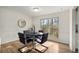 Dining room with wood floors, black table, and a large window with wooded view at 1111 Clairemont Ave # P5, Decatur, GA 30030