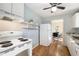 White kitchen features stainless steel appliances and views into the dining room at 1111 Clairemont Ave # P5, Decatur, GA 30030
