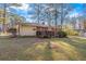 Spacious backyard with a deck, mature trees, and partial fencing, perfect for outdoor enjoyment and privacy at 1672 Zemory Dr, Tucker, GA 30084