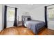 Calm bedroom with a comfortable bed, wooden floors, and soft gray accents throughout at 1672 Zemory Dr, Tucker, GA 30084