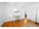 Bright bedroom with hardwood floors and neutral walls, featuring a simple desk and a stylish floor lamp at 1672 Zemory Dr, Tucker, GA 30084
