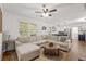 Bright living room with large sectional sofa and hardwood floors, seamlessly connected to the kitchen at 1672 Zemory Dr, Tucker, GA 30084