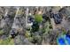 High-angle aerial view showing the house within a green, tree-filled neighborhood and a nearby tennis court at 1926 N Decatur Ne Rd, Atlanta, GA 30307