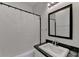 Classic bathroom with a granite sink, a framed mirror, and a tub with a white shower curtain at 1926 N Decatur Ne Rd, Atlanta, GA 30307