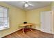 Bedroom with light yellow walls, hardwood floors, a ceiling fan and a sunny window with horizontal blinds at 1926 N Decatur Ne Rd, Atlanta, GA 30307