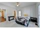 Spacious bedroom with neutral carpet, ceiling fan, and two side tables with a view of the adjoining bathroom at 1926 N Decatur Ne Rd, Atlanta, GA 30307
