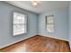 Light blue bedroom featuring hardwood floors and two large windows with great natural light at 1926 N Decatur Ne Rd, Atlanta, GA 30307