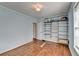 Empty light blue bedroom with hardwood floors and an open wire shelving unit for plenty of storage at 1926 N Decatur Ne Rd, Atlanta, GA 30307