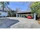 Large carport with two parked cars and an adjacent patio area with a table and chairs at 1926 N Decatur Ne Rd, Atlanta, GA 30307