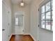Inviting entryway with hardwood floors, a stylish light fixture, and a clear view into the living room at 1926 N Decatur Ne Rd, Atlanta, GA 30307