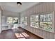 Bright sunroom featuring beautiful windows, shelving, wood-paneled walls, and unique tile floors at 1926 N Decatur Ne Rd, Atlanta, GA 30307