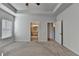 Open and airy bedroom with neutral tones, ceiling fan, and entryways to closet and bathroom at 2908 Rambler Dr, Loganville, GA 30052