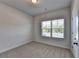 Bedroom with plush carpet, one window, and white trim at 2908 Rambler Dr, Loganville, GA 30052