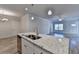 Kitchen island featuring stainless steel sink and granite countertops in an open floor plan at 2908 Rambler Dr, Loganville, GA 30052