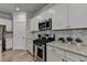 Well-lit kitchen boasts granite countertops, stainless steel appliances, and white subway tile backsplash at 2908 Rambler Dr, Loganville, GA 30052