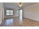 Bright living room with hardwood floors, a ceiling fan, and a large window for natural light at 2908 Rambler Dr, Loganville, GA 30052