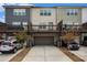 Rear view of townhome with attached garages and upper level decks at 3651 Princeton Ave, Atlanta, GA 30337