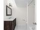 Bathroom with dark wooden vanity topped with white countertop and framed mirror above at 6851 Roswell Rd # L1, Atlanta, GA 30328