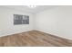Bedroom featuring hardwood floors, a window and neutral paint at 6851 Roswell Rd # L1, Atlanta, GA 30328
