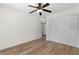 A bedroom featuring neutral paint and wood floors with access to a closet at 6851 Roswell Rd # L1, Atlanta, GA 30328