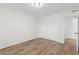 Bedroom featuring hardwood floors, closet and door to the rest of the home at 6851 Roswell Rd # L1, Atlanta, GA 30328