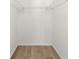 This walk-in closet offers laminate wood flooring and plenty of storage with shelving installed at 6851 Roswell Rd # L1, Atlanta, GA 30328