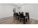 The dining room features hardwood floors and an elegant chandelier above the wood table set at 6851 Roswell Rd # L1, Atlanta, GA 30328