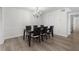 Bright dining room features hardwood floors and chandelier lighting above an elegant wood table set at 6851 Roswell Rd # L1, Atlanta, GA 30328