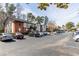 View of the exterior and parking lot of a traditional brick and cream colored condominium at 6851 Roswell Rd # L1, Atlanta, GA 30328
