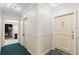 A well-lit hallway with carpet and neutral paint leads to the unit's front door at 6851 Roswell Rd # L1, Atlanta, GA 30328