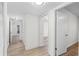 Hallway with neutral paint and wood floors leads to rooms with access to closet space at 6851 Roswell Rd # L1, Atlanta, GA 30328