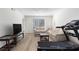 Bright living room with neutral-toned furniture, laminate floors and a large window at 6851 Roswell Rd # L1, Atlanta, GA 30328