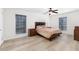 Spacious main bedroom with wood floors, two windows and bedroom furniture at 6851 Roswell Rd # L1, Atlanta, GA 30328