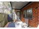 A covered patio with brick facade offers a quiet outdoor space at 6851 Roswell Rd # L1, Atlanta, GA 30328