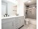 This modern bathroom features a double sink vanity and a tiled shower and tub combination at 725 Victoria Station Blvd, Lawrenceville, GA 30043
