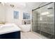 A modern bathroom features a soaking tub, glass shower and large windows at 725 Victoria Station Blvd, Lawrenceville, GA 30043
