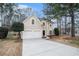 Two-story home featuring a two-car garage, neutral stucco and stone accents, and a well-manicured front yard at 725 Victoria Station Blvd, Lawrenceville, GA 30043