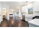 Well-lit kitchen with stainless steel appliances, white cabinetry, hardwood floors, and an open view to other living areas at 725 Victoria Station Blvd, Lawrenceville, GA 30043