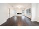 Spacious living room with hardwood flooring, a modern fireplace, large windows, and neutral white paint at 725 Victoria Station Blvd, Lawrenceville, GA 30043
