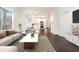 Bright living room with modern decor open to the kitchen and dining area, creating a great living space at 725 Victoria Station Blvd, Lawrenceville, GA 30043