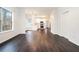 Open-concept living space with hardwood flooring, modern white kitchen, and natural light from a large window at 725 Victoria Station Blvd, Lawrenceville, GA 30043