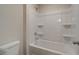 Bathroom tub and shower combination with white tile surround and white toilet at 746 River Gardens Dr Se # 746 River Gardens Dr Se, Atlanta, GA 30354