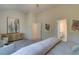 Spacious bedroom with light-colored walls, carpet floors, ensuite bathroom and artwork at 746 River Gardens Dr Se # 746 River Gardens Dr Se, Atlanta, GA 30354