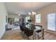 Open-concept dining room area with wood floors and a modern chandelier lighting the glass dining table at 746 River Gardens Dr Se # 746 River Gardens Dr Se, Atlanta, GA 30354
