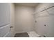 A basic laundry room with utility sink and a wire shelf above the appliances at 746 River Gardens Dr Se # 746 River Gardens Dr Se, Atlanta, GA 30354