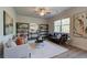 Bright living room features modern ceiling fan, neutral furniture, and decorative shelving at 746 River Gardens Dr Se # 746 River Gardens Dr Se, Atlanta, GA 30354